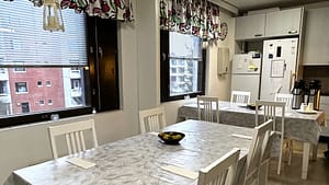 Kuva keittiötiloista, jossa on pöytäryhmiä.