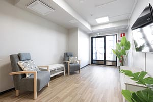 Oleskelutila kahdella nojatuolilla ja kaapistolla.