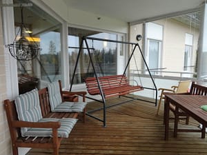 Terassi, jossa keinu ja muita terassikalusteita.