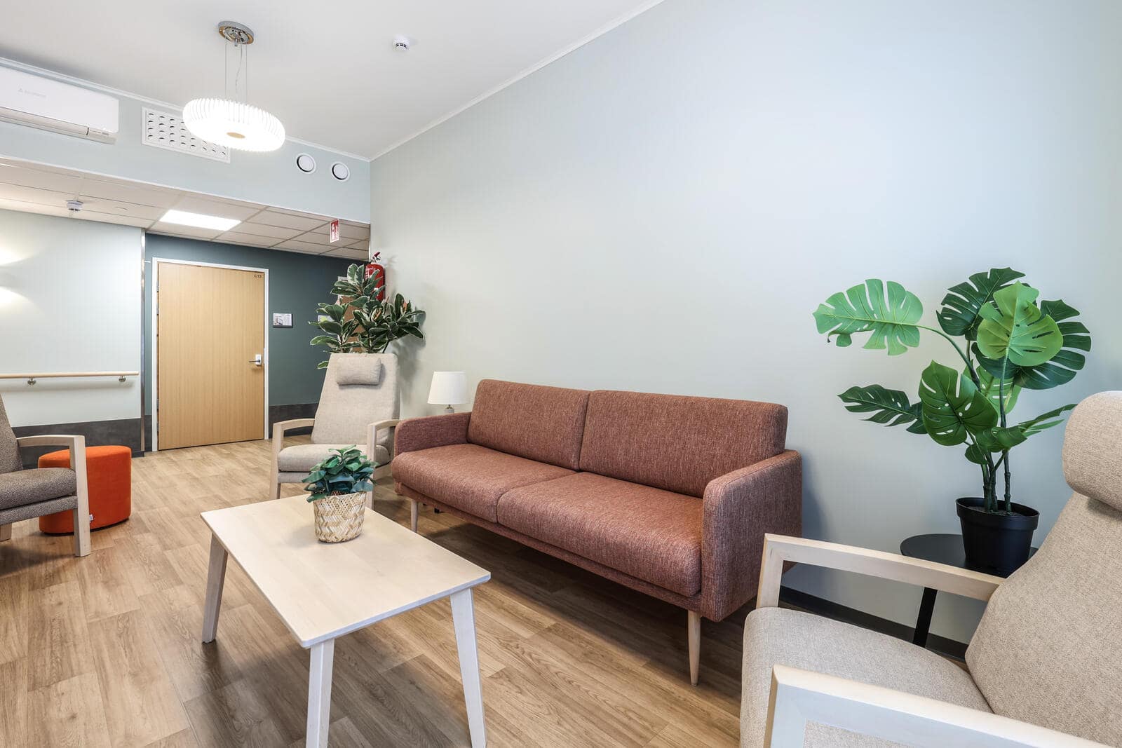 Valoisa oleskelutila sohvalla ja nojatuoleilla