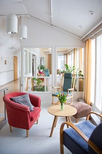 Valoisa käytävä, jossa huonekaluja.