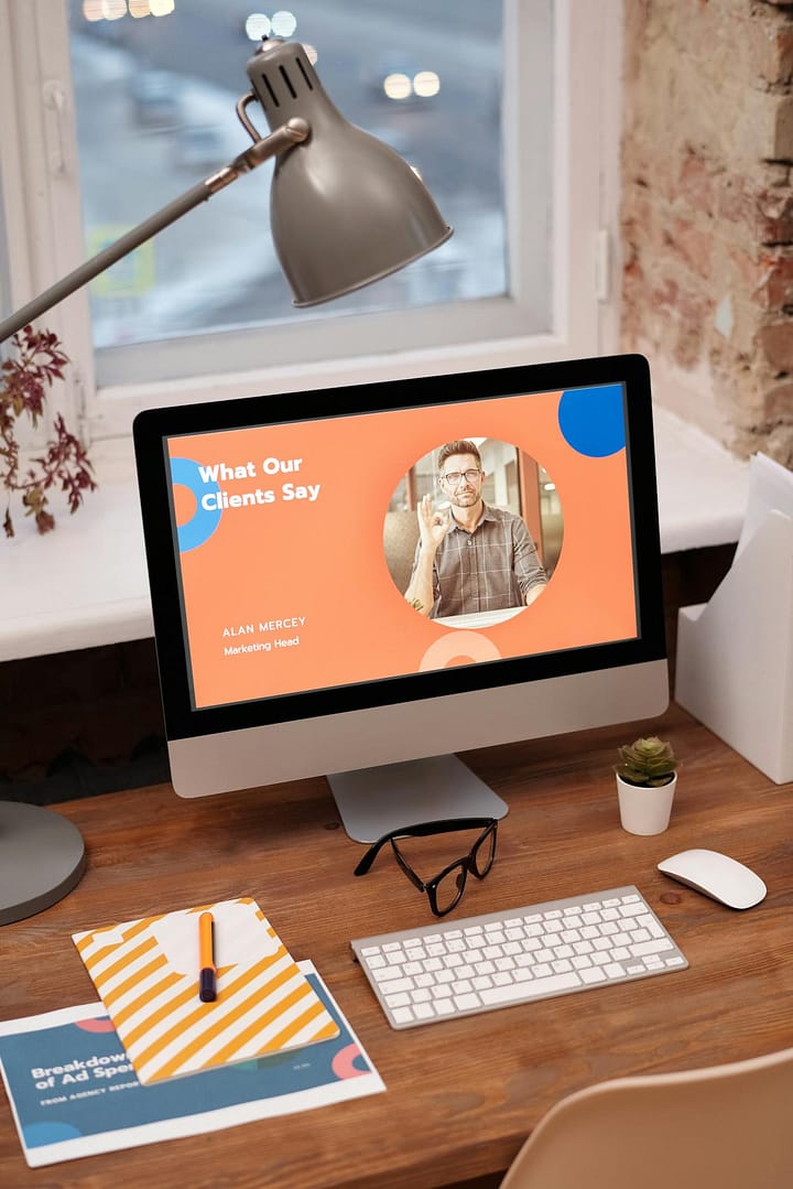 Stylish home office setup with computer showcasing client testimonials.